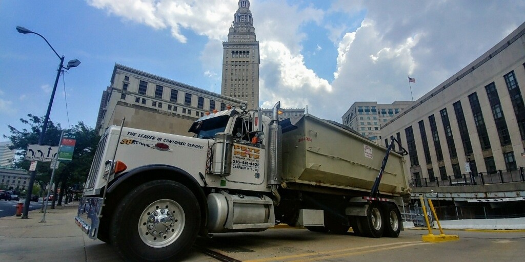 Pete and Pete, Inc truck carrying a roll off dumpster rental