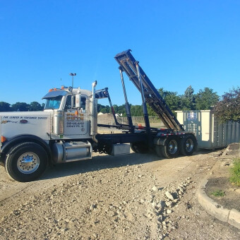 Pete & Pete roll off dumpster truck unloading a dumpster rental in Cleveland, Ohio