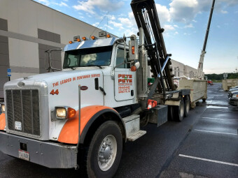 Pete & Pete roll off dumpster truck unloading a dumpster rental in Cleveland, Ohio