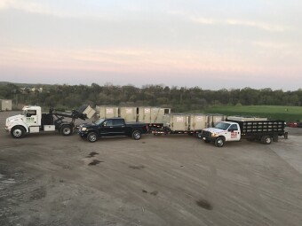 Pete and Pete front load dumpsters loaded onto trucks and ready for delivery in Cleveland, Ohio