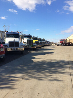 Fleet of roll-off container trucks.