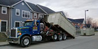 A 40 yard roll off container being switched out with another empty dumpster