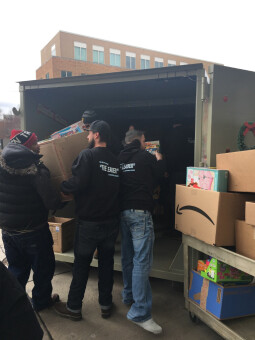 The team at Pete and Pete Inc. filling a container with more donated gifts.
