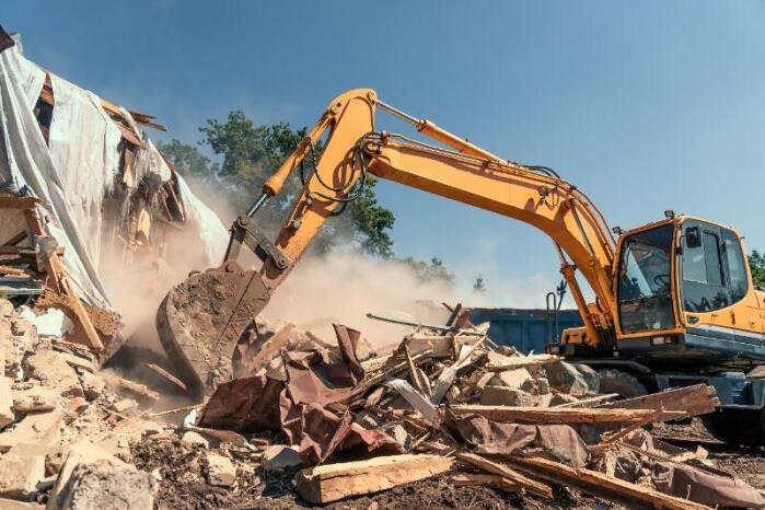 Excavator crushing debris at the Boyas Recycling landfill in Cleveland
